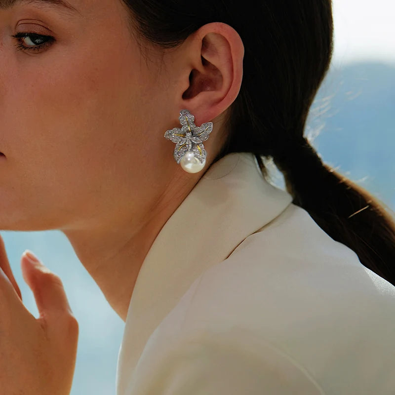 Boucles d'oreilles élégantes en perles d'imitation en forme de fleur, ornées de pierres CZ étincelantes. Un accessoire luxueux et féminin, parfait pour les mariages, les fêtes et les occasions spéciales.